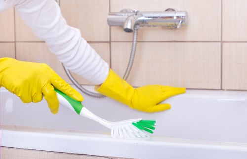 Cleaner wearing PPE during a deep cleaning service in Bow