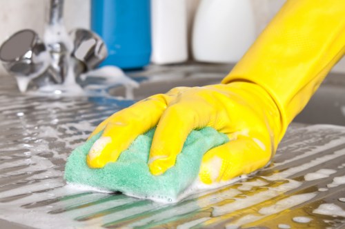 Professional cleaner in Bow sanitising a bathroom as part of a domestic service